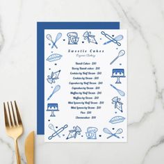 a blue and white wedding menu on top of a table with gold utensils