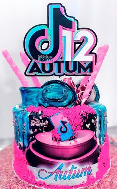 a birthday cake decorated with pink and blue icing, including the number one on top