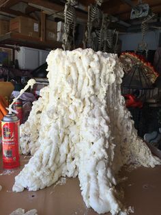 a large pile of white stuff sitting on top of a table next to a can