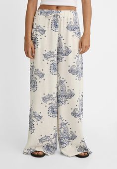 Wide-leg printed linen blend trousers with elasticated waistband - Women's Trousers | Stradivarius United States Floral Print Wide Leg Bottoms In Viscose, Relaxed Fit Patterned Bottoms With Elastic Waistband, Patterned Relaxed Fit Bottoms With Elastic Waistband, Casual Printed Rayon Bottoms, Patterned Bottoms With Elastic Waistband And Relaxed Fit, Patterned Wide Leg Beach Bottoms, Patterned Pants With Elastic Waistband For Vacation, Vacation Patterned Pants With Elastic Waistband, Casual Linen Floral Print Bottoms