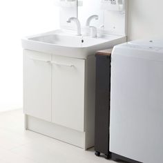 a white sink sitting next to a washer and dryer