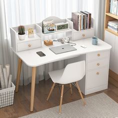 a white desk with a laptop computer on top of it next to a bookshelf