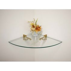 a glass shelf with some flowers on it