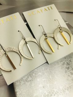 "Simple large crescents that are a glossy silver and will work with almost any occasion. The silver is a glossy silver alloy plated over brass which is a mix of different base metals. The finish is glossy because it is rack plated. This means that pieces are hand hung so they receive the optimal amount of coverage. The gold is an 18 K gold plating over brass. The earrings are lead safe. You have a choice of two different combinations. 1) Gold and Silver 2) Silver The earrings are 1 & 1/4\" i Elegant Half Moon Metal Earrings, Elegant Half Moon Earrings For Everyday, Elegant Half Moon Everyday Earrings, Elegant Everyday Half Moon Earrings, Modern Crescent Jewelry For Pierced Ears, Modern Silver Crescent Earrings, Modern Crescent Earrings, Elegant Nickel-free Half Moon Earrings, Elegant Half Moon Nickel-free Earrings