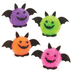 four different colored bats with smiling faces on their backs and wings are shown in this image