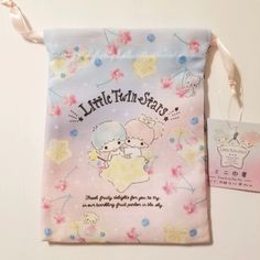 Sanrio Little Twin Stars Drawstring Bag. This Little Twin Stars Drawstring Bag Is Perfect To Carry All Your Accessories , Makeup, Jewelry, Notes, Stationery Or Anything You Need. It Features Twin Stars And Has Flower Prints On The Bag And It Reads " Fresh Fruity Delights For You To Try. In Our Twinkling Fruit Parlor In The Sky ". Great To Carry With You Anywhere. Size: 18.5 Cm X 14 Cm Double Sided Prnt Sweet White Bag Perfect For Gifts, Sweet White Bags As Gift, Sweet White Bags For Gifts, Cute Multicolor Bags For Birthday, Cute Multicolor Birthday Bags, Sanrio Backpack, Sanrio Little Twin Stars, Rainbow Purses, Hello Kitty Y2k