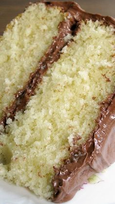 a slice of cake with chocolate frosting on a plate