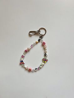 a key chain with flowers and beads on it