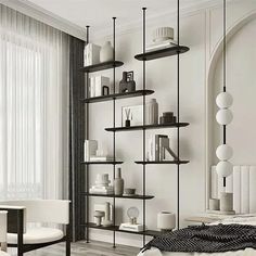 a white bedroom with black and white decor on the walls, bookshelves and chairs