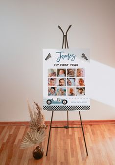 a sign that is sitting on top of a wooden floor next to a potted plant