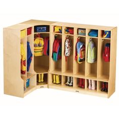 a child's wooden locker with several coats and shoes