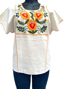 Mexican Embroidered Top.  Beautiful and rich embroideries.   The top would be used as casual or for fiesta cultural event.  Measurement: XLarge Petite Neck depth: 4 inches Neck Circumference: 26 inches Sleeve Width Circumference : 17 inches   Bust Circumference: 50 inches Waist Circumference: 50 inches Tunic Length: 25 inches Pre washed, will not shrink. Care: Machine Wash/Tumble dry If you have any question, I will be happy to assist you. Shipping Method: My first priority is to provide an excellent service.  During peak shipping season delays are expected, please apologize for any inconvenience shipping service could cause. I will always do my best to ship the item as soon as possible.  Thank you very much for your business. Vintage Cotton Tops With Intricate Embroidery, Folk Style Cotton Fabric With Floral Embroidery, Cotton Embroidered Fabric With Folk Style, Folk Style Cotton Fabric With Intricate Embroidery, Vintage Cotton Top With Floral Embroidery, Traditional Embroidered Crew Neck Top For Spring, Cotton Folk Blouse With Machine Embroidery, Folk Style Cotton Blouse With Machine Embroidery, Bohemian Cotton Fabric With Floral Embroidery