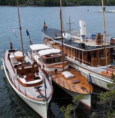 two boats are docked in the water next to each other