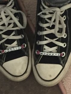 a pair of black and white tennis shoes with the word champion on them, are seen from above