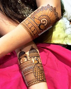 a woman's arm with henna tattoos on it