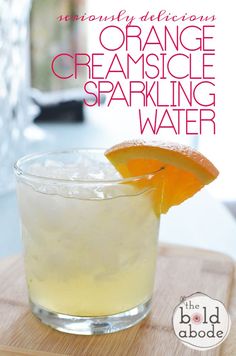 the orange creamsice sparkling water is garnished with an orange slice