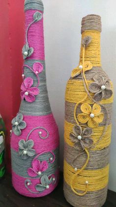 three vases made out of twine with flowers on them