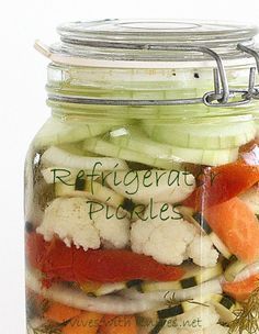 there is a jar full of vegetables and the words refrigerate pickles in it