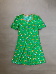 Vintage green mini dress with blue and orange flower pattern, short sleeved in soft jersey.  Estimated size S, Made in Sweden by Vinetta, marked VDN (the Swedish Institute for Informative Labelling, used 1951-1973) Measurements To help make sure the item will fit; use a soft tape measure and compare these with your own or on an item in a similar style. These measurements are just a guide, if you are uncertain please contact us with your measurements and we can advise best fit. Shoulders: 32cm Chest: 42cm x 2 Waist: 37cm x 2 Length: 87cm Any questions? Send us a dm! Scandinavian Green, Vintage Mini Dress, Vintage Mini Dresses, Green Floral Pattern, Swedish Brands, Green Mini Dress, 60s Dress, Swedish Design, Short Sleeve Mini Dress