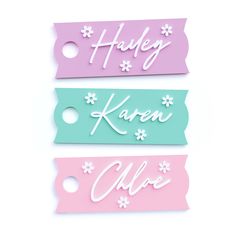 three name tags with flowers on them