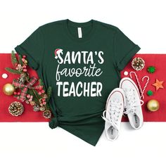 santa's favorite teacher t - shirt with christmas decorations and sneakers on the floor