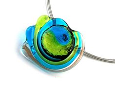 a blue and green glass pendant on a silver chain