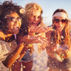 three young women having fun at the beach stock photo