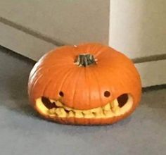 a pumpkin with its mouth open on the floor