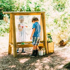 two young children standing in front of an easel