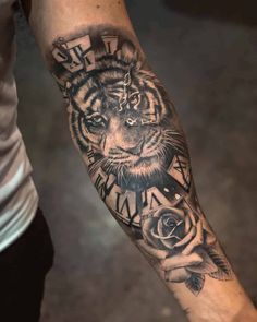 a man with a tiger and roses tattoo on his arm