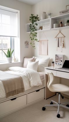 a bedroom with a bed, desk and computer on it in front of a window