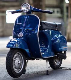 a blue scooter is parked on the street