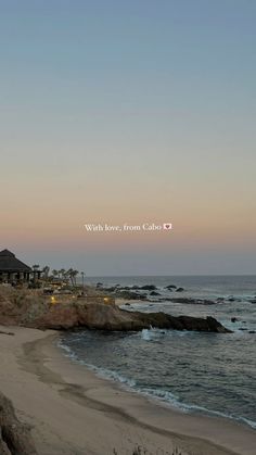 the beach is next to some rocks and water at sunset with love from cabo written on it