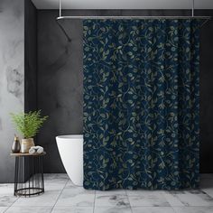 a bathroom with a blue shower curtain next to a white bath tub and black walls