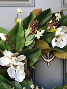 a wreath with white flowers and green leaves