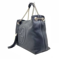 This Gucci black leather bag features the interlocking GG logo. It is large enough to carry all of your essentials in style. The shoulder straps are made of gold chain, but come with leather shoulder padding for comfort. This designer handbag instantly elevates your everyday look. Includes authenticity cards and Gucci dust bag.    Model: 536196  Black Leather  Embossed interlocking G Detachable leather tassel  Double chain shoulder straps with leather shoulder pad  Inside hook closure  Light fin Gucci Crossbody Shoulder Bag With Logo Hardware, Gucci Rectangular Bag With Logo Hardware, Gucci Shoulder Bag With Logo, Rectangular Gucci Bag With Logo Hardware, Gucci Shoulder Bag With Logo Hardware, Gucci Leather Shoulder Bag With Logo Hardware, Gucci Shoulder Bag With Logo Hardware For Everyday Use, Gucci Crossbody Bag With Logo, Modern Gucci Bag With Logo Hardware