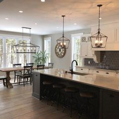 a large kitchen with an island in the middle