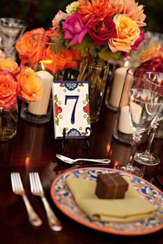 the table is set with flowers and candles