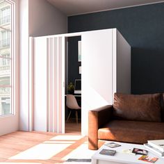 a living room with a brown couch and white partitions in the wall behind it