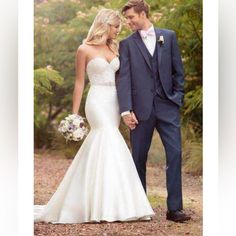 the bride and groom are holding hands in front of some trees at their wedding day