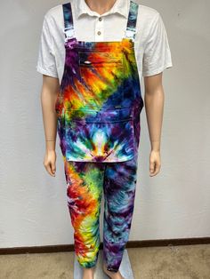 Ice tie dye medium men's overalls. These overalls have 8 pockets! 1 zipped chest, 2 side hand pockets, 1 center front, a large multi-storage pocket, 2 knee pad and a rear pocket. The straps have elastic on back and offers adjustability for a comfortable fit. Heavy cotton.  Made from 100% cotton, is machine wash cold with dark colors, machine dry low. Fun front pocket hangs at the waist, more of a pouch! 2 buttons on both sides of hips, open for easy on and off, also has a zipped fly in front, straps have a plastic easy open button. Can roll up if too long in length. Festival wear for sure! One of a kind, all hand dyed by me! Measurements are garment laid out flat  18 inches from edge to edge at waist top of buttons 20 inches at hips edge to edge 22 inches from top of bib down front to crot Cotton Overalls With Pockets For Festival, Multicolor Cotton Overalls For Festival, How To Tie Dye Overalls, Pride Overalls, Festival Multicolor Cotton Overalls, Acid Wash Cotton Overalls With Pockets, Tye Dye Overalls, Painters Overalls, Cotton Pre-washed Overalls