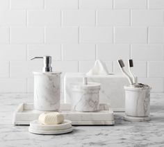 marble bathroom accessories including soap dispenser, toothbrush holder and soap dish