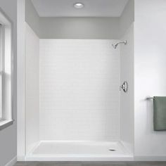 an empty bathroom with white walls and wood flooring is seen in this image from the shower