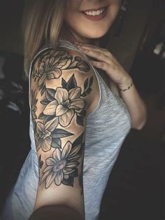 a woman with a flower tattoo on her arm