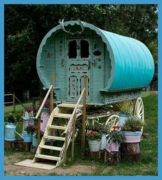 a blue covered wagon with steps leading up to it