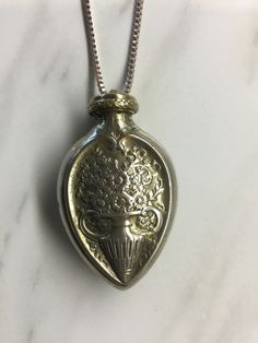 A antique silver plated perfume pendant with a flower motef on both sides.  The pendant will not open I believe the perfume that was in it sealed it shut.  Beautiful pendant! Perfume Pendant, Perfume Necklace, The Perfume, Antique Perfume, Vintage Perfume, A Flower, Pendant Necklaces, Antique Silver, Silver Plate