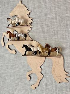 a wooden horse shelf with horses on it