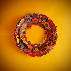 the paper wreath is made up of leaves and flowers