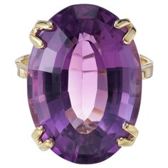 Mid- Century Amethyst cocktail ring. 18.00 carat oval amethyst in a simply double 4 prong 14k yellow gold setting. Circa 1950's. 1 oval purple amethyst, approx. 18.00cts Size 7 and sizable 14k yellow gold Stamped: 14k 7.2 grams Width at top: 20.8mm Height at top: 11.2mm Width at bottom: 2.4mm Amethyst Cocktail Ring, Antique Wedding Bands, Yellow Gold Cocktail Ring, Diamond Sapphire Engagement Ring, Antique Engagement Rings Vintage, Antique Jewelry Rings, Woman Jewelry, Antique Bracelets, Vintage Sapphire