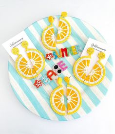 a clock made out of orange slices on top of a blue and white striped plate